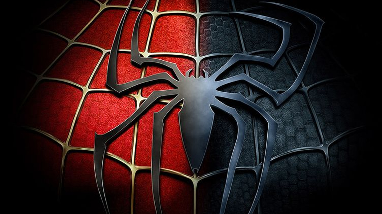 Gros plan sur une araignée noire et rouge sur une toile, illustrant la symbolique de Spider-Man et la peur de l’inaction.
